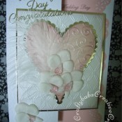 Feathers & Orchids Wedding card. Orchids hand cut and embossed in parchment, Dies used include Sizzix Framelits plain and scalloped Hearts dies, Couture creations intrinsic and tied together embossing folders and Britannia dies wedding day sentiments. - craftybabscreativecrafts.co.uk