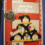 Pile Of Penguins Christmas card made using Woodware circle, flower and bow punches, Cuttlebug 2x2.75 winter jelly embossing folder, Quickutz Holly Jolly gift set dies merry christmas sentiment and Polka dot border die - craftybabscreativecrafts.co.uk