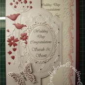White on White Wedding card with red accents made using Couture creations tied together embossing folder, Spellbinders Papillons dies, Spellbinders small floral ovals die, Spellbinders labels 28 dies, Memory Box Prim Poppy die, Memory Box Tall Chloe stem dies and memory Box honeyblossom twig die - craftybabscreativecrafts.co.uk
