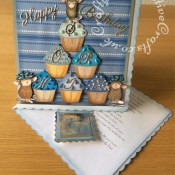 8"x8" House-Mouse Cup Cake Easel Card made using Stamped and coloured House-Mouse images, and Quickutz Revolution Cupcake die, Britannia Happy Birthday Sentiment die, Cheery Lynn Delicate Lace Script Alphabet dies, Quickutz nesting scalloped square dies and Cuttlebug 2x2 embossing folder. - craftybabscreativecrafts.co.uk