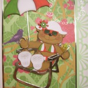A4 Italian Holiday themed retirement/leaving job card made using mostly custom made wooden dies for bear & hat, Quickutz revolution umbrella die, Quickutz 2x2 martini glass die, Go Kreate Boo bear on holiday die for sunglasses and Cuttlebug Disney cut & emboss set for suitcase. - craftybabscreativecrafts.co.uk