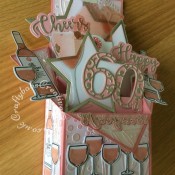 Wine Themed 60th Birthday Pop Up Box card made using a variety of dies including; CARD MAKING MAGIC DIE SETS SOLID & OVERLAY NUMBER & SUFFIX, Unbranded nesting stitched stars dies, i Craft Cheers & Happy dies, Apple Blossom Die Set Cheers! Wine Bottles & Glass, Apple blossom dies, embossing folder and stamps from Issue 161 of Simply cards & Papercraft magazine and Crafters companion Gemini Expressions Metal Die – Uppercase and lower case Alphabet Sets. - craftybabscreativecrafts.co.uk