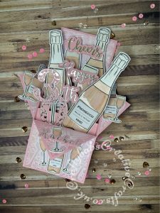 Pink Prosecco themed Pop Up Box card made using various digi-stamps from Craftworld Premium members free digi-stamps cheers collection, dies including; CARD MAKING MAGIC DIE SETS SOLID & OVERLAY NUMBER & SUFFIX, i Craft Cheers & Happy dies, embossing folder and stamps from Issue 161 of Simply cards & Papercraft magazine and Crafters companion Gemini Expressions Metal Die – Uppercase and lower case Alphabet Sets. - craftybabscreativecrafts.co.uk