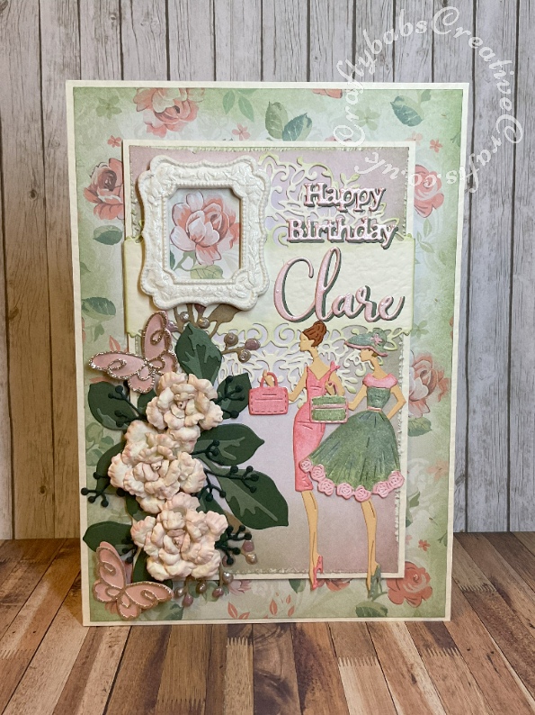 Vintage style birthday card made using various dies including: Heartfelt Creations Vintage floret dies for roses, Altenew JUmbo Garden Picks and Garden picks dies for leaves, unbranded dies for berry foliage, Tattered Lace sentiments 2014 for 'Happy Birthday' Sizzix Thinlits Elle Upper and Lower case Alphabet dies for name, Cardmaking Magic Petunia Wrap die for lace background, Poppy Stamps Devyn Butterfly trio dies and Tattered Lace 3D Pretty Party Dress Die Set. Frame made with WRMK Mold and paperclay. - craftybabscreativecrafts.co.uk